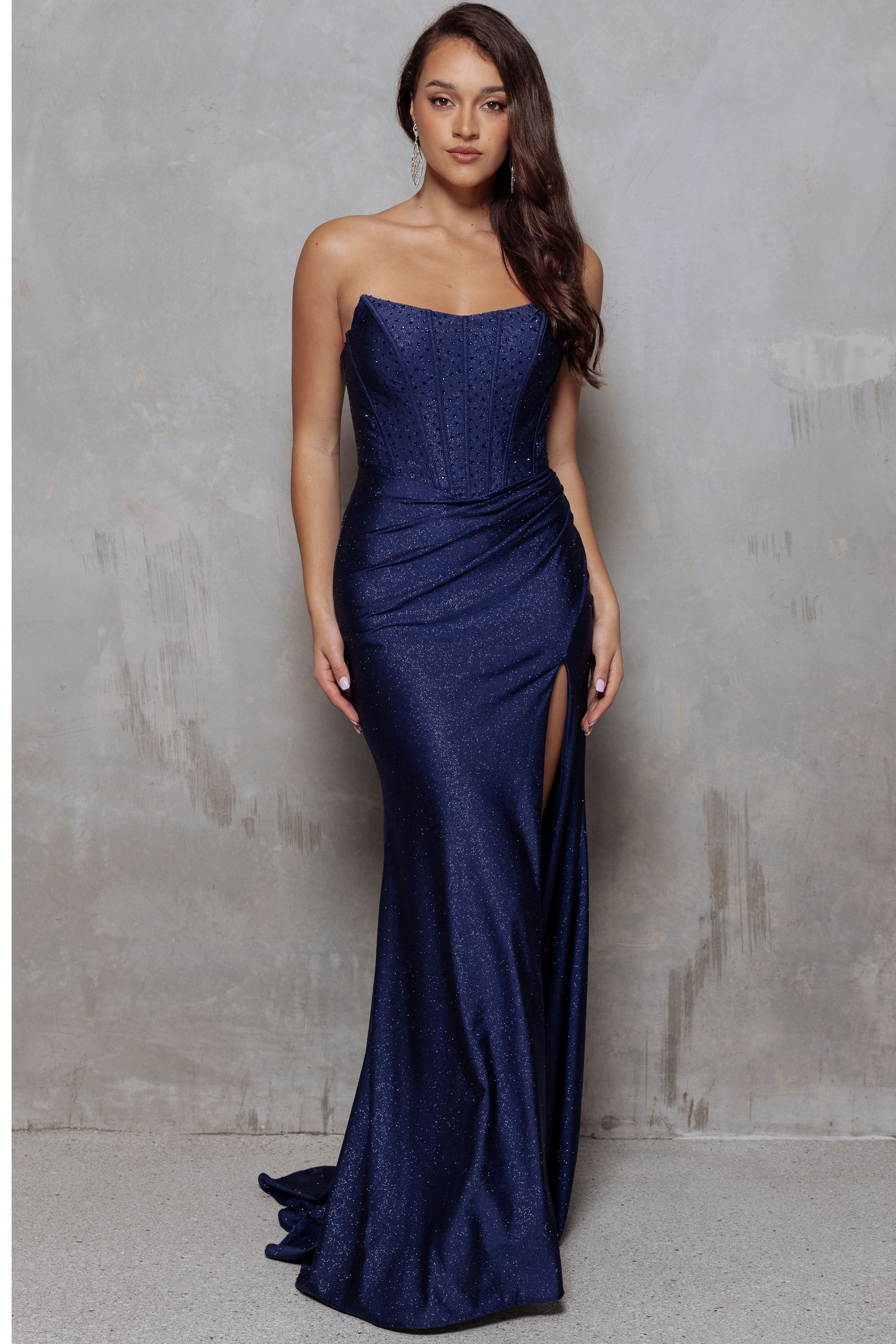Navy blue glitter jersey formal dress with strapless corseted bodice and lace up back