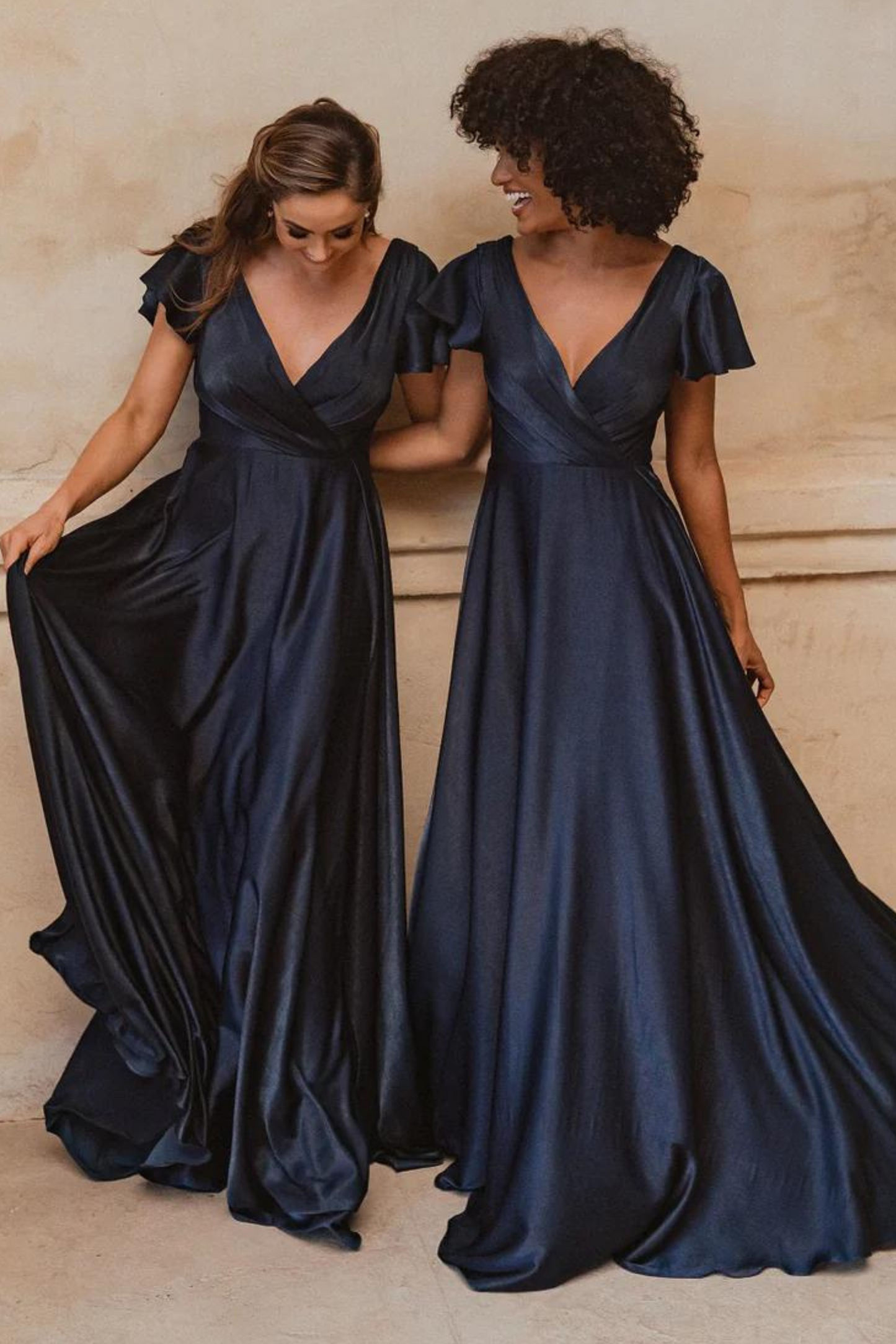 A-line navy bridesmaids dress with V neckline and flutter sleeves