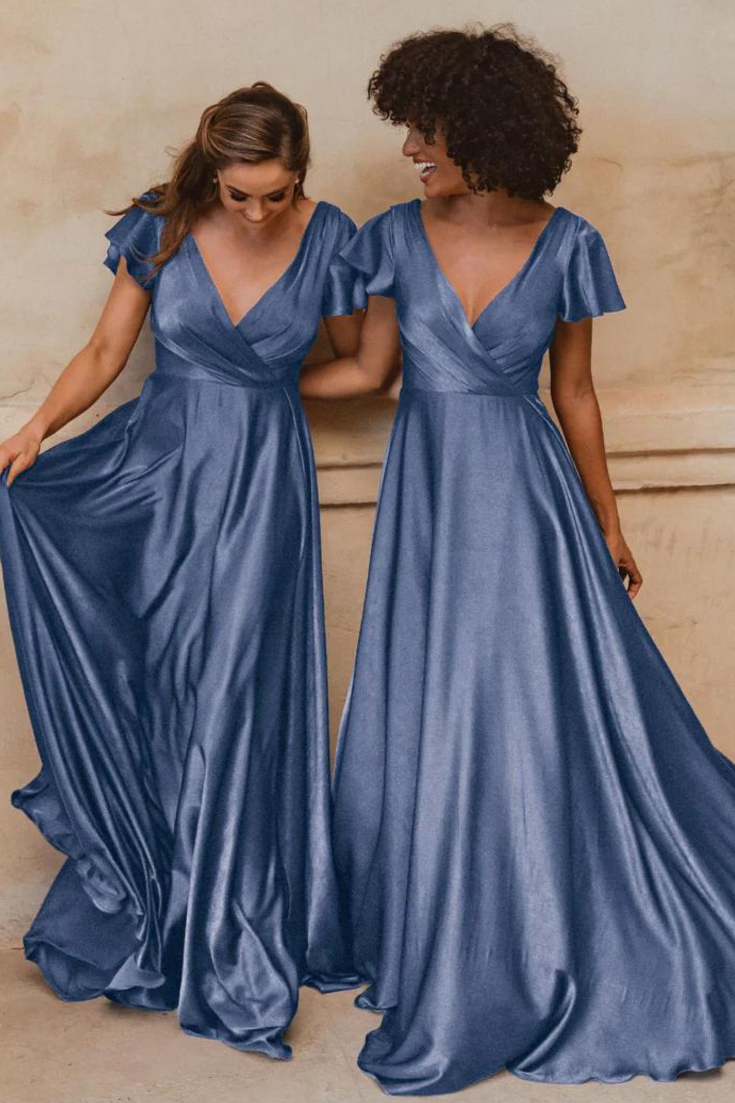 A-line dusty blue bridesmaids dress with V neckline and flutter sleeves