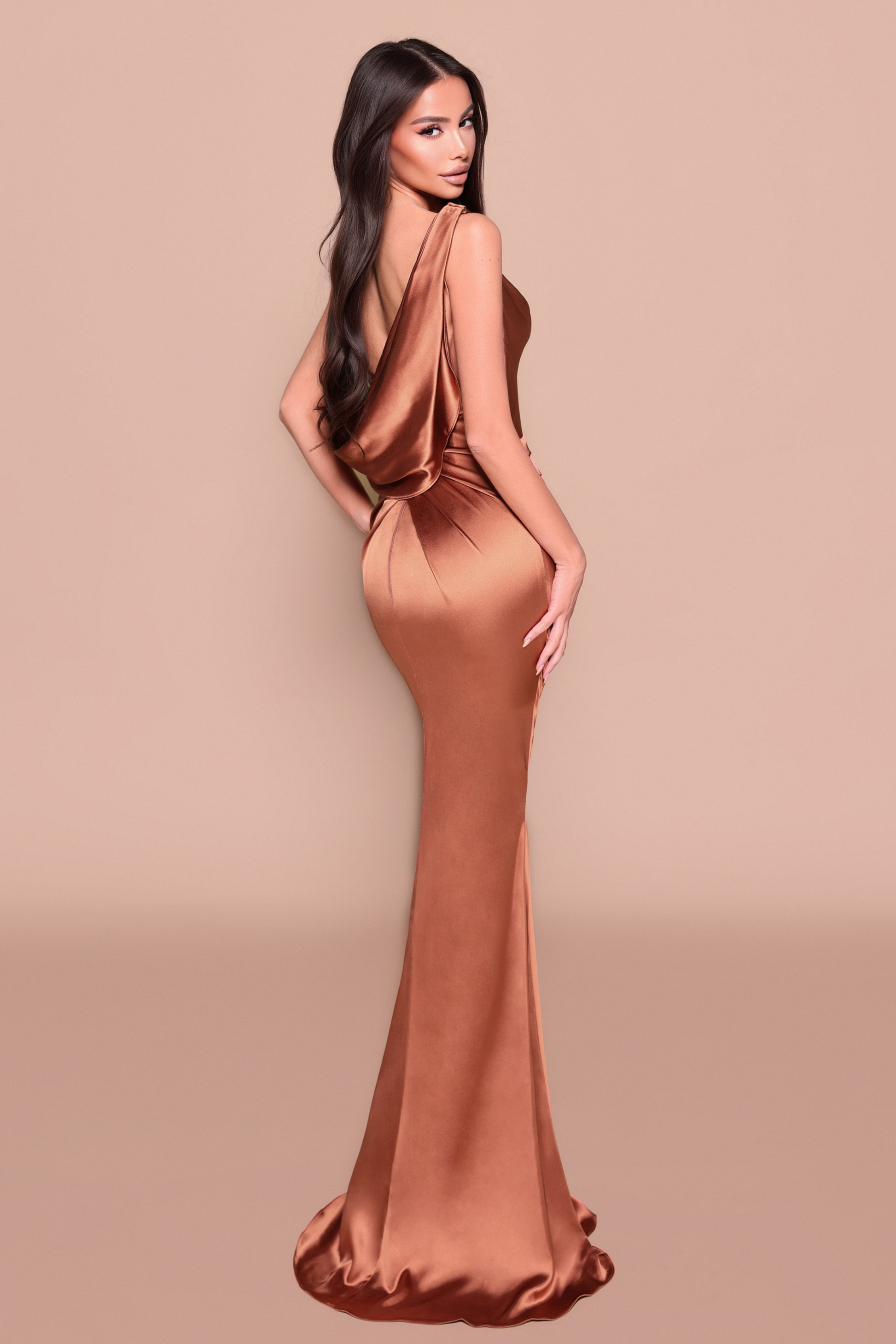 Woman wearing a bronze evening gown showing the back design