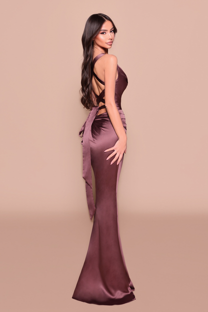 Woman wearing a long fitted, elegant chocolate dress showing back design