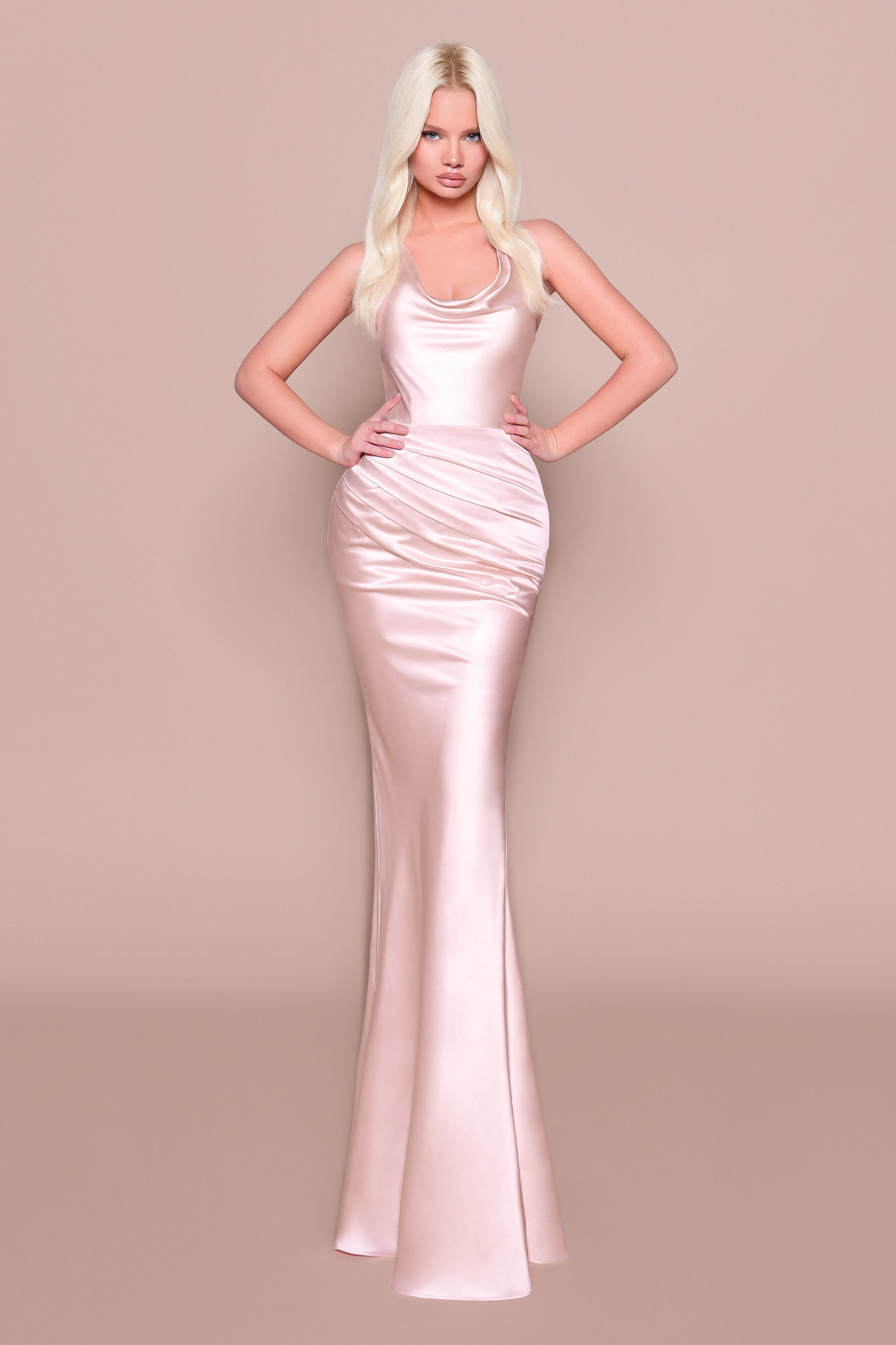Woman wearing a long fitted, elegant pale pink dress 