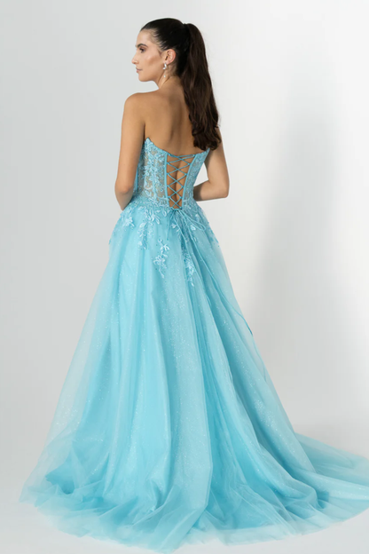 Woman wearing a light blue evening gown with intricate back design on a white background