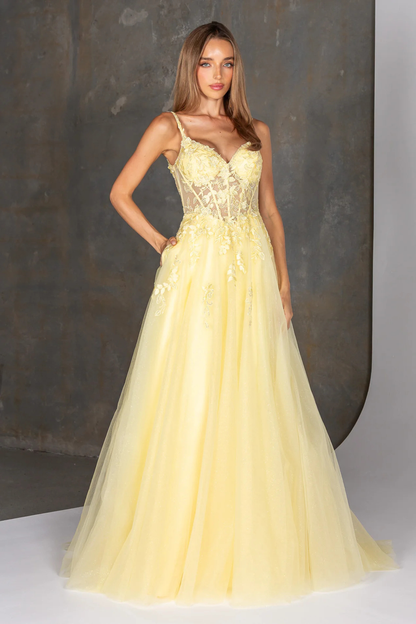Woman wearing a yellow evening gown against a neutral background