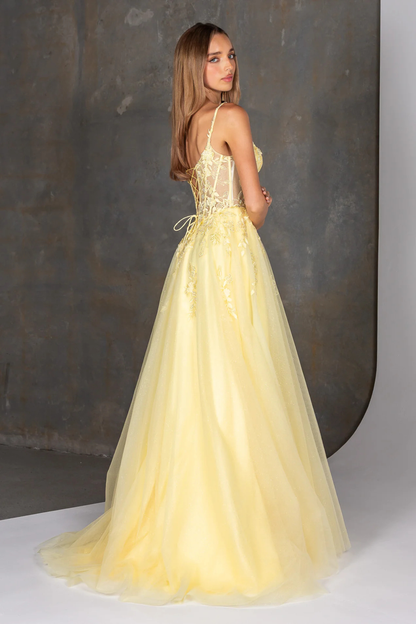 Woman wearing a yellow evening gown against a neutral background
